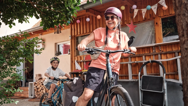 Frau und Kind fahren mit Follow-Me Kupplung zuhause los